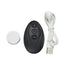 Black remote control with small white Puck Vibe, and USB cable, on a white background