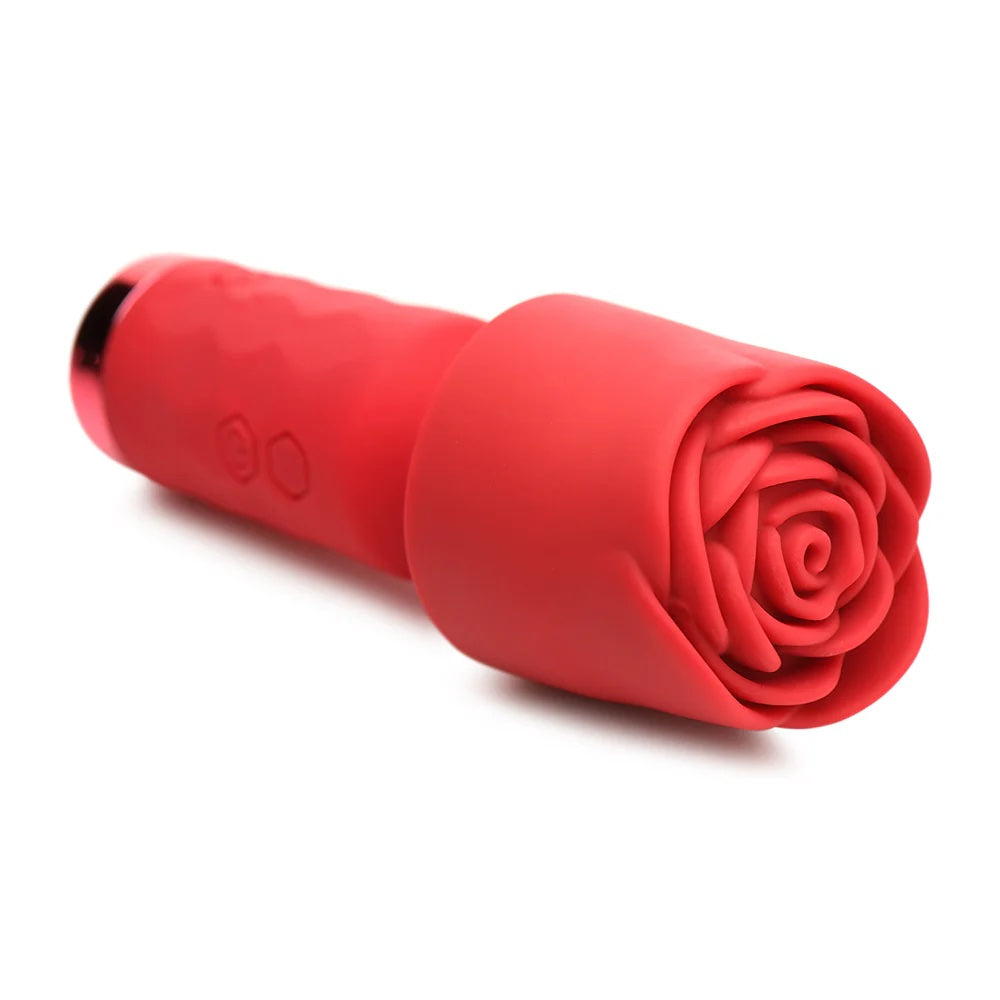 Red Pleasure Rose Mini Wand , with silicone rose cover, laying horizontal to the ground, zoomed in to show rose cover's texture