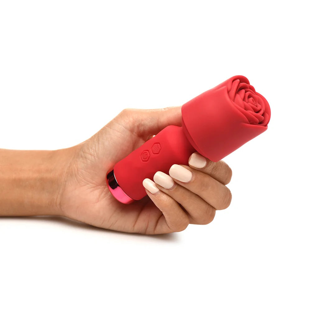 Red Pleasure Rose Mini Wand , with silicone rose cover on head, held in a hand