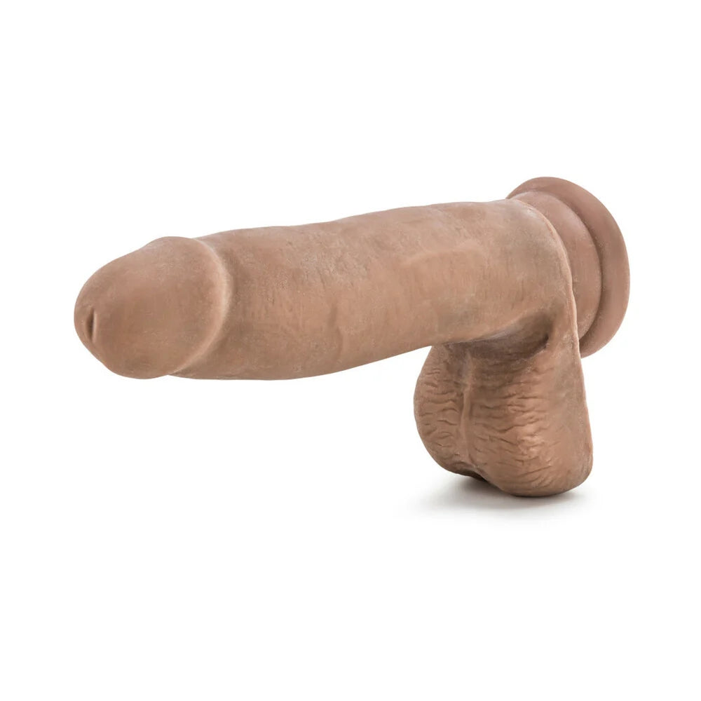Caramel Au Naturel Sensafeel dual density dildo with suction cup horizontal to the ground with the tip facing out
