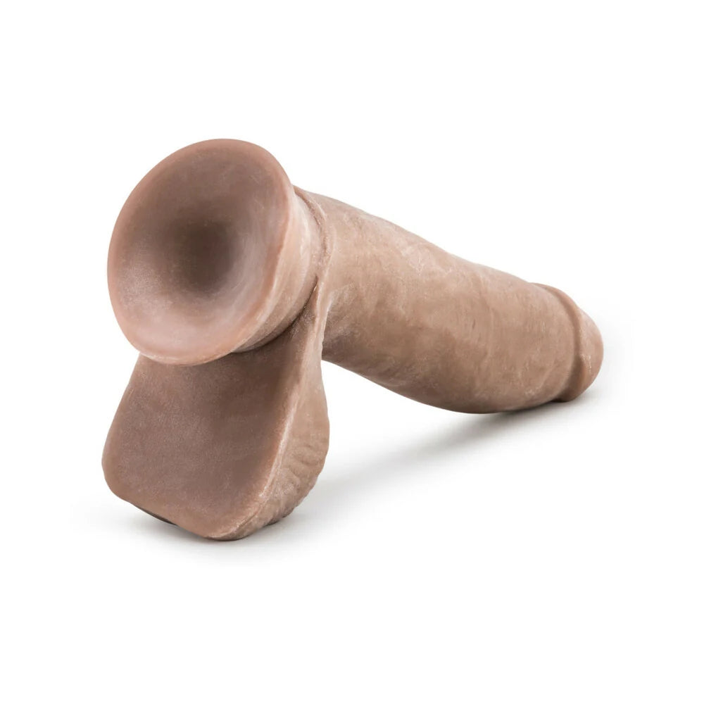 Caramel Au Naturel Sensafeel dual density dildo with suction cup horizontal to the ground with the suction cup