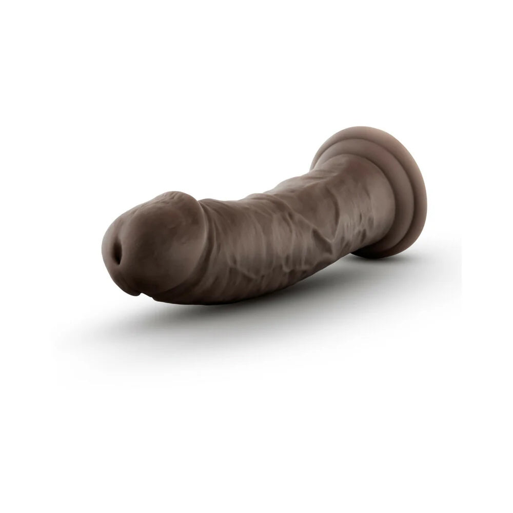 Chocolate Au Naturel Sensafeel 7.5 dildo laying horizontal to the ground with the tip facing out