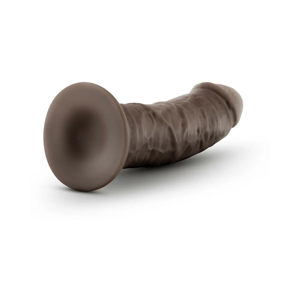 Chocolate Au Naturel Sensafeel 7.5 dildo laying horizontal to the ground with the suction cup exposed