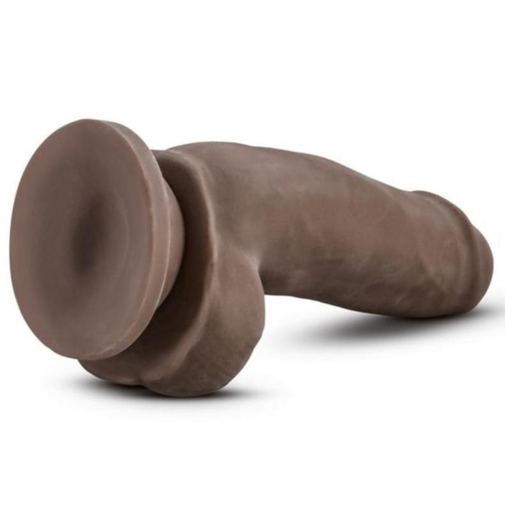 Chocolate Au Naturel Fat Boy Dual Density dildo with balls and suction cup horizontal totnhe ground with the suction cup exposed