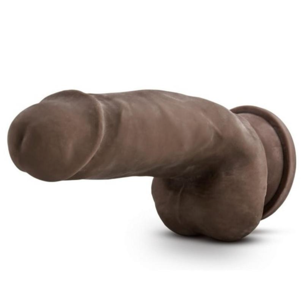 Chocolate Au Naturel Fat Boy Dual Density dildo with balls and suction cup horizontal to the floor, with the tip facing forward