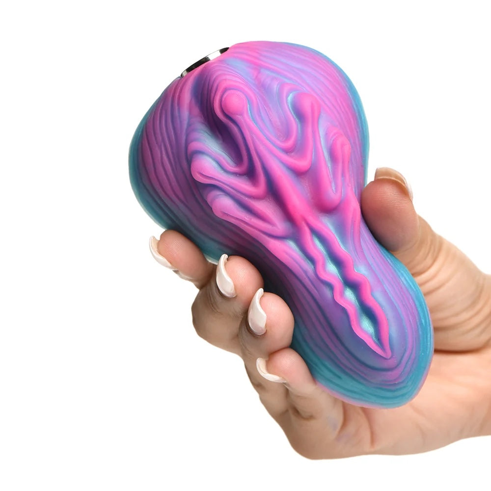 Creature Cocks Vulvaron pink and blue silicone vulva- like fantasy vibrating rechargeable remote controlled silicone grinder in hand