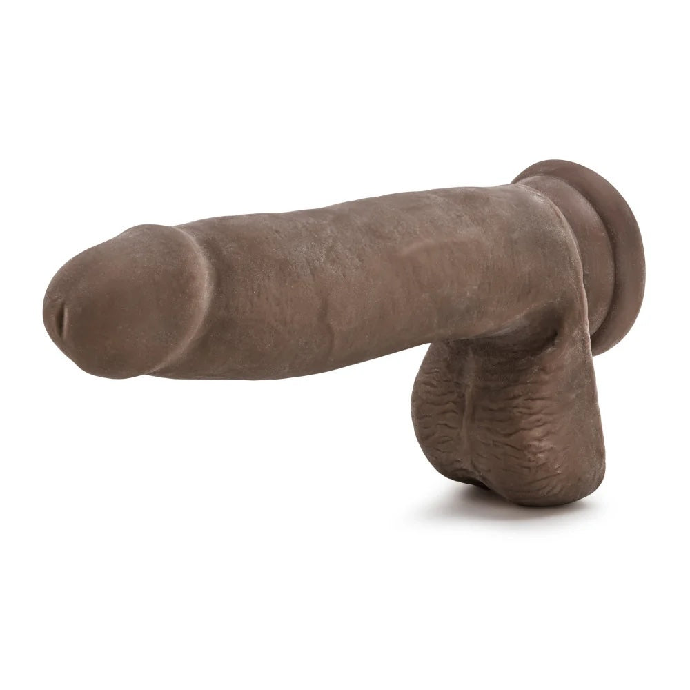 Chocolate Au Naturel dual density sensafeel dildo with balls and suction cup horizontal to the ground with balls down and tip facing forward