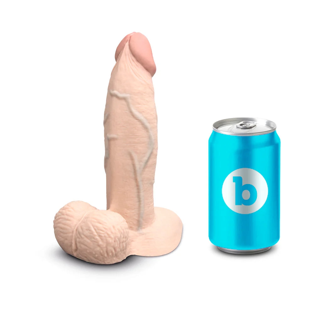 Slipskin Grithy Sliding Skin silicone dildo in Cream ,standing on its base next to a soft drink can for size reference