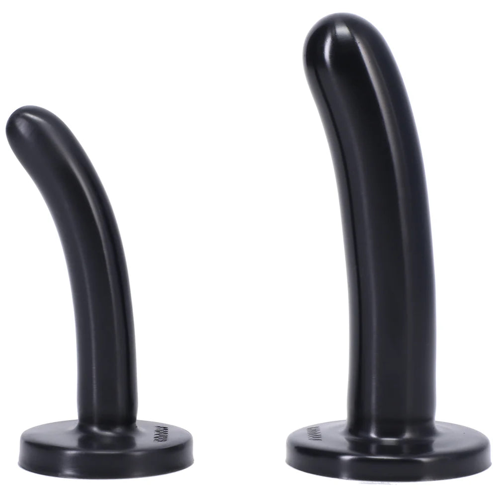 Black Bend over Beginners strap on kit close up of black silicone dildos standing upright on the flat bases