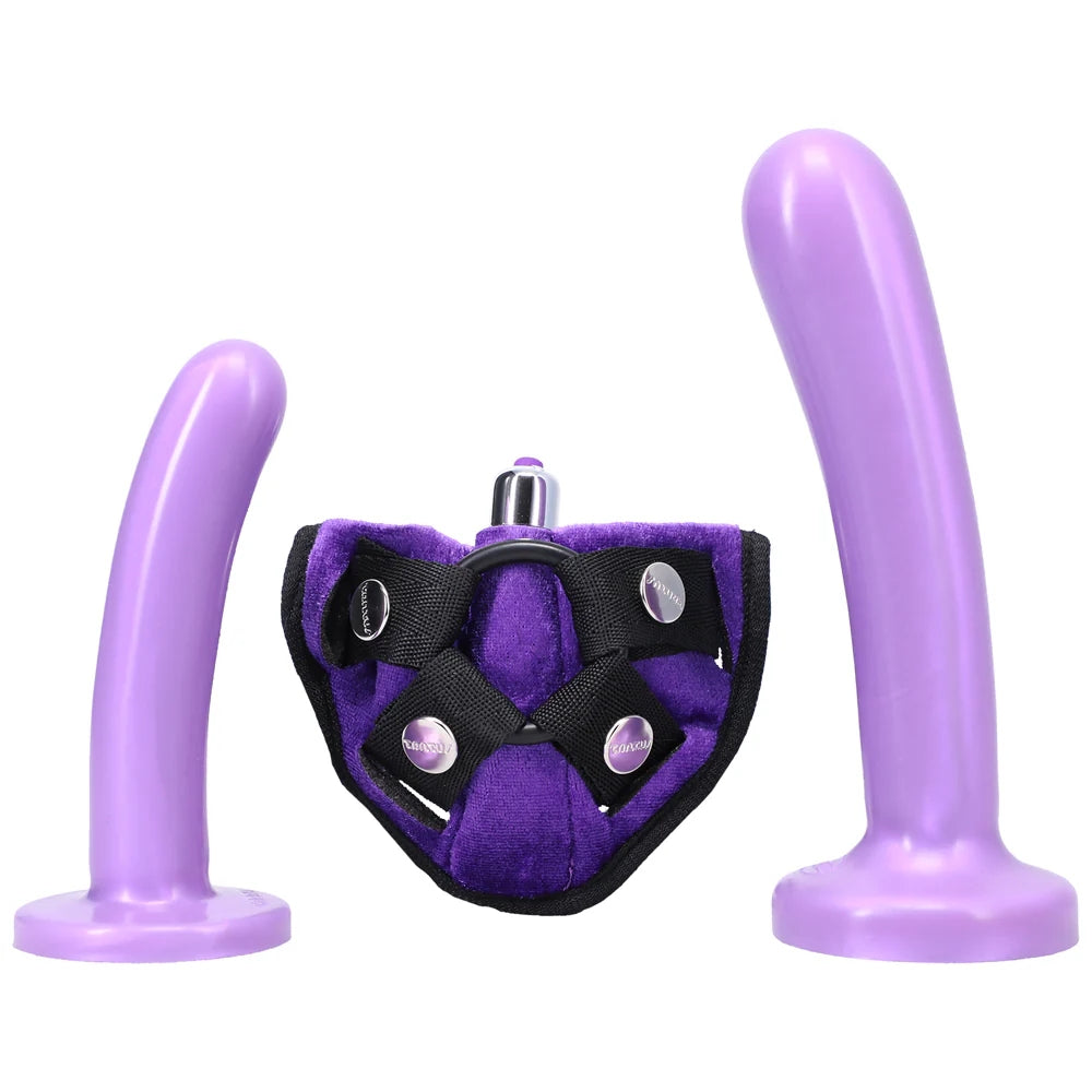 Purple Tantus Bend over Kit with purple velvet harness and 2 purple silicone dildos standing on the flat base next to the harness