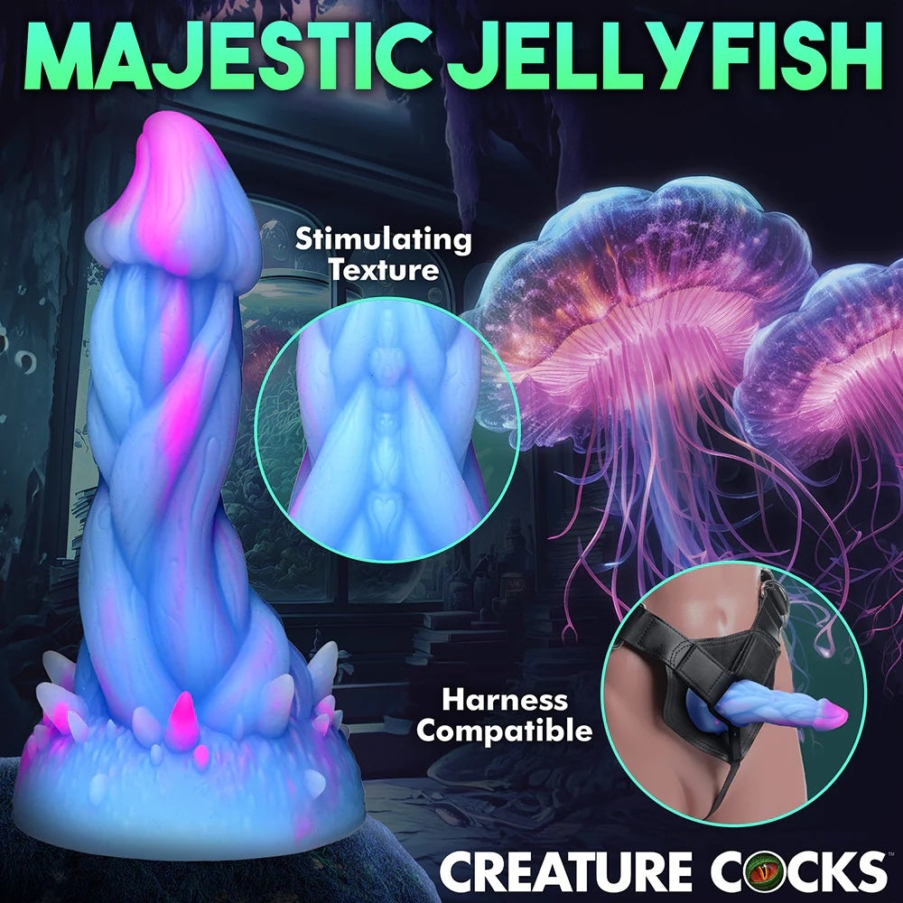 XR Brands Creature Cocks Nomura Jellyfish shaped, pink, purple and blue fantasy silicone dildo shown in aharness with a seacape background, with zoom in on texture