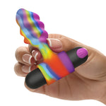 Hand holding the Bang rainbow-colored anal vibrator on a white background