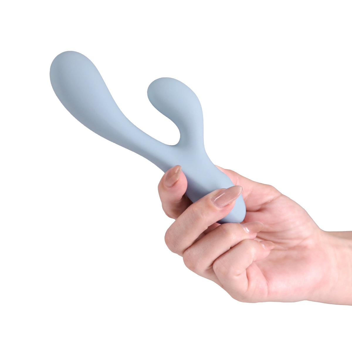 A light blue silicone personal massager with a curved, organic shape, held in a person's hand against a plain white background.