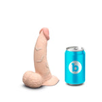 b Vibe Cream colored slip skin dildo, flat on its base with tip pointed up next to a standard soft drink can for size reference