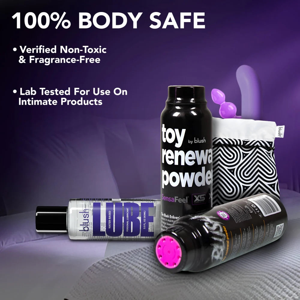 Blush sensafeel toy powder next to a bottle of lubricant and a pouch of toys on a purple back ground