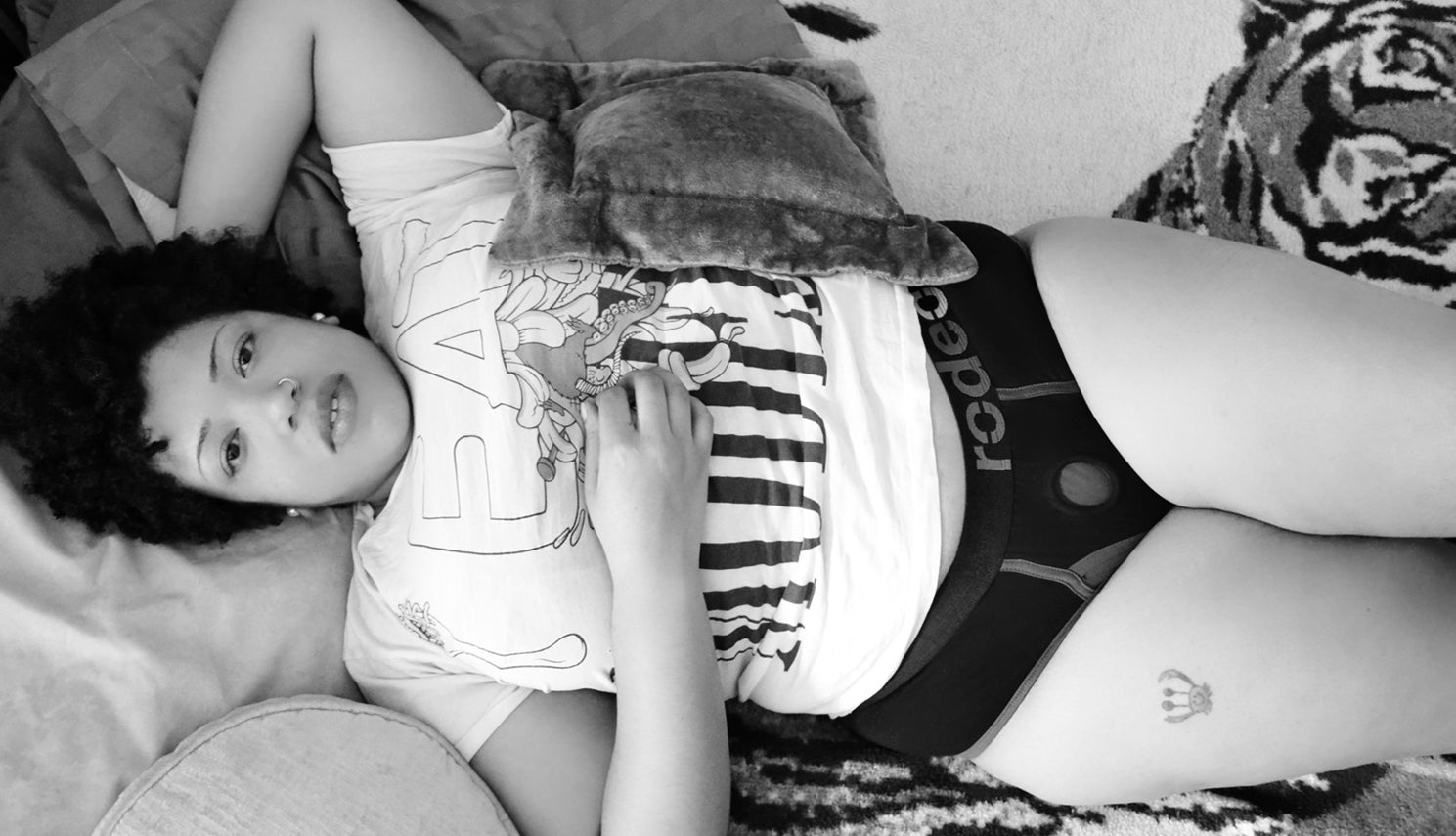model laying on bed wearing rodeoh brief harness