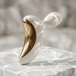 Lunar Curve silicone crescent moon shaped clitoral vibrator in white and gold with app control capability, from the side and back