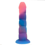 Nexus Loli swirl ribbed silicone dildo in Aurora glow, a pink, blue and purple mix, flat on its suction base, from the back of the shaft