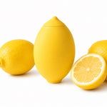 Nexus vibes lemon pucker sucking yellow silicone lemon shaped vibrator, sitting on its opening, next to cut cut lemon fruit on a white background