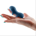 Fingerella finger vibrator slid over the pointer finger of a hand, with the stimulating side facing upwards