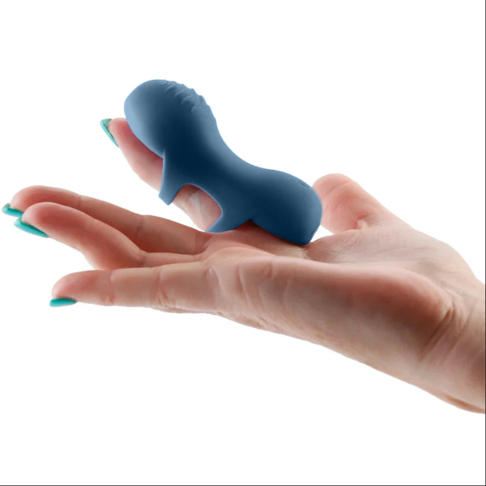 Fingerella finger vibrator slid over the pointer finger of a hand, with the stimulating side facing upwards
