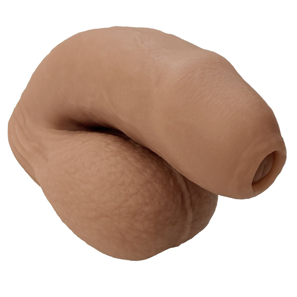 Nexus silicone foreman, uncut silicone packers in caramel , in flaccid position from the front and side 3 quarters view with balls exposed