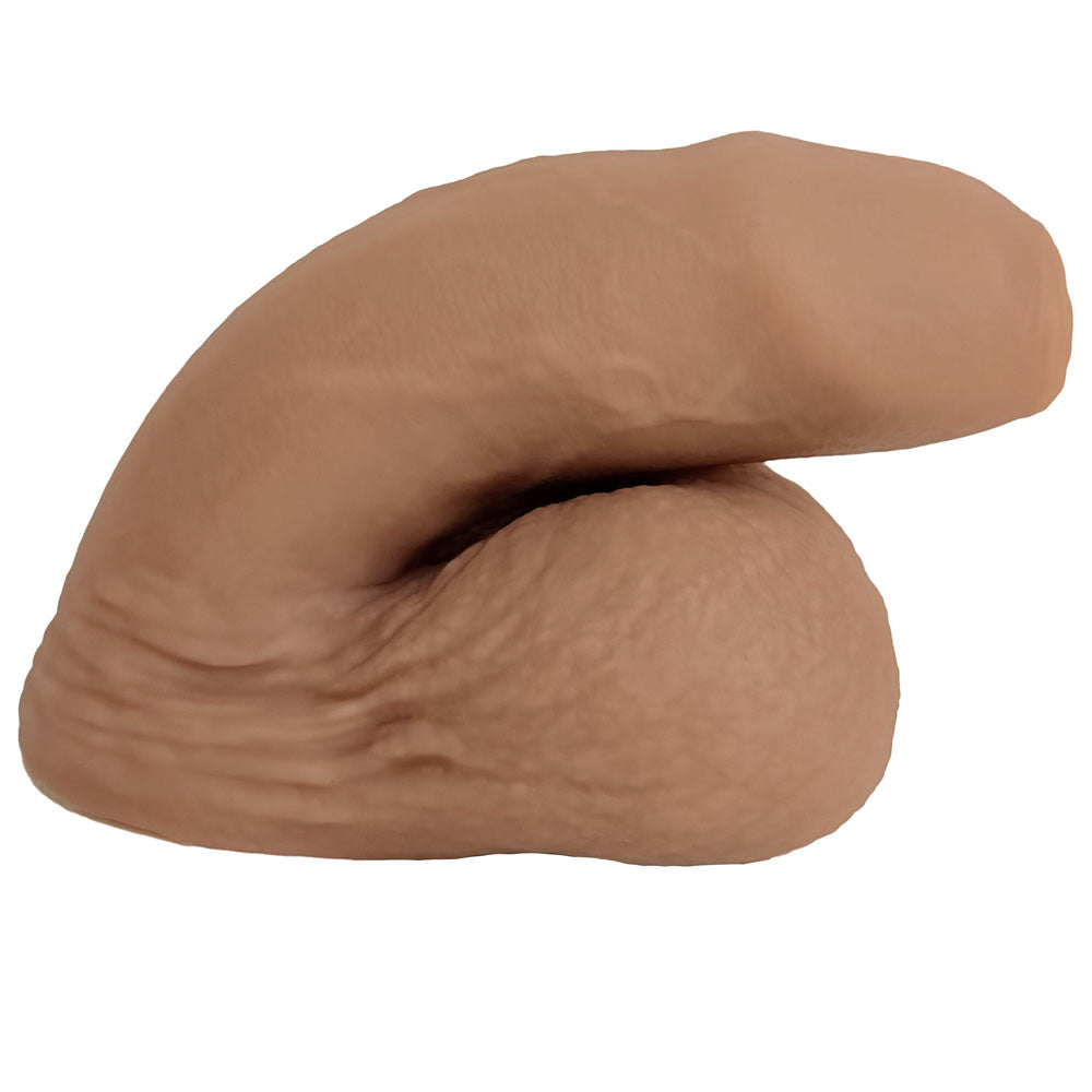 Nexus silicone foreman, uncut silicone packers in caramel , in flaccid position from the side 