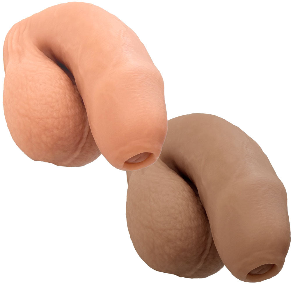 Nexus silicone foreman, uncut silicone packers in caramel and vanilla, in flaccid position from the front