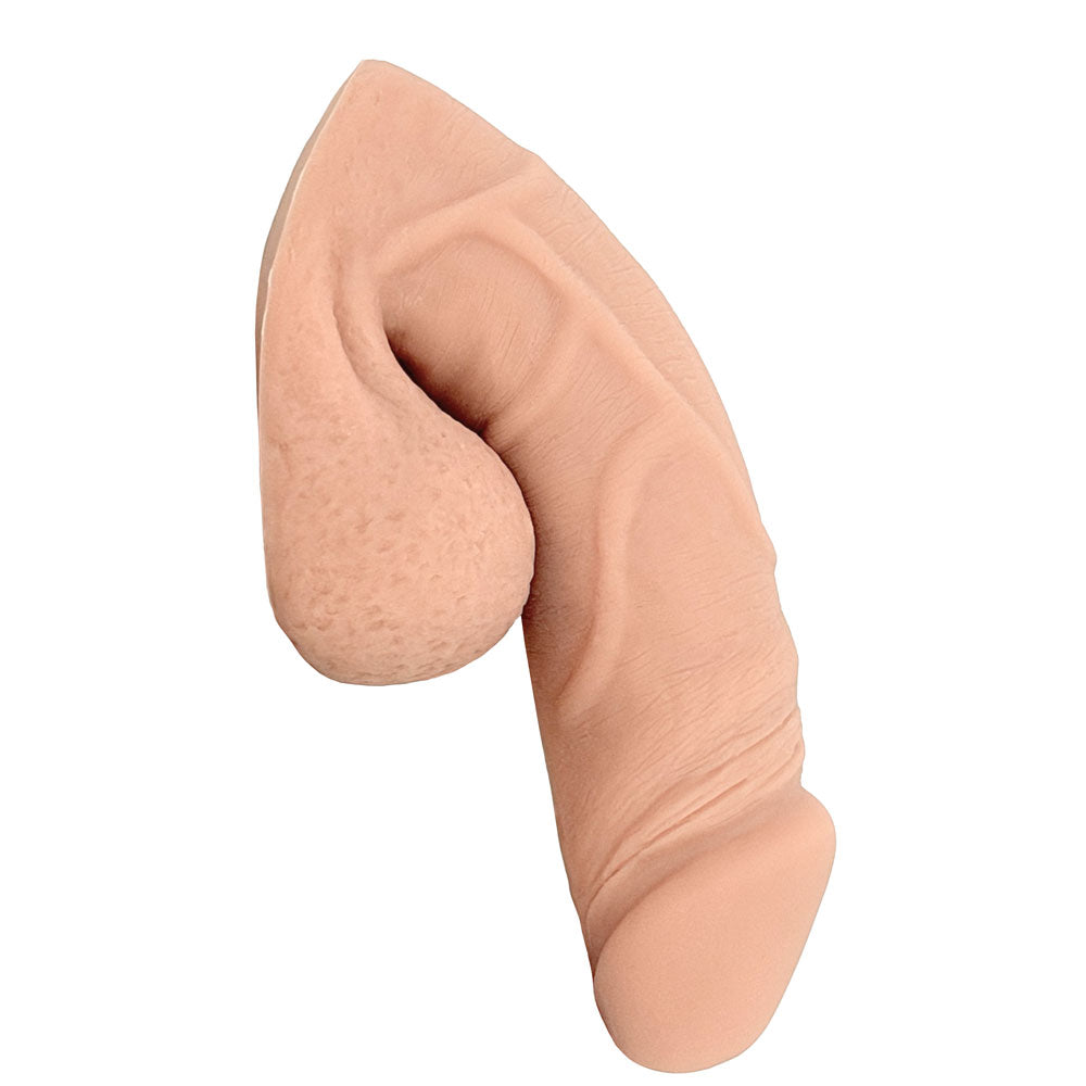 Freeform Medium 5 inch silicone soft  ftm packer, in vanilla color from the side in the flaccid packed position
