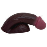 CHOCOLATE SILICONE VECTOR 5 INCH FTM SILICONE PACKER, FROM THE SIDE IN THE PACKED FLACCID POSITION, FLAT ON ITS BASE