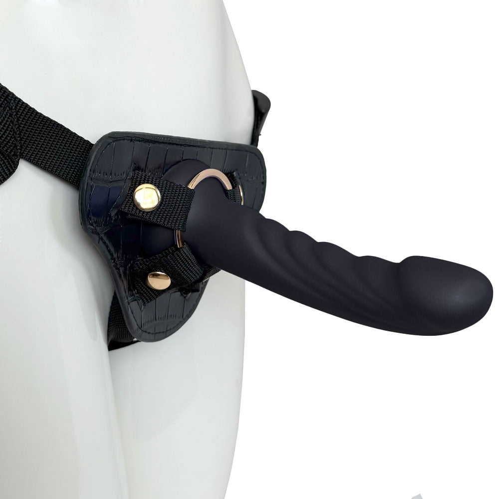 Nexus Fun and Love harness kit with adjustable black strap on harness and black tease silicone dildo, with dildo inserted into the harness and harness on a mannequin, angled from the side