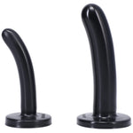 Black Bend over Beginners strap on kit close up of black silicone dildos standing upright on the flat bases