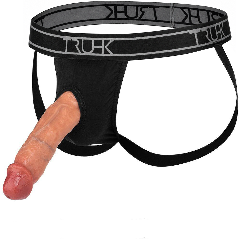 Black men's jockstrap underwear with a gray elastic waistband featuring the brand name 'TRUHK' in white, shown with a realistic dildo protruding from the front opening against a white background.