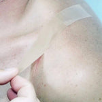 unique silicone scar care tape being applied to a scar on a shoulder
