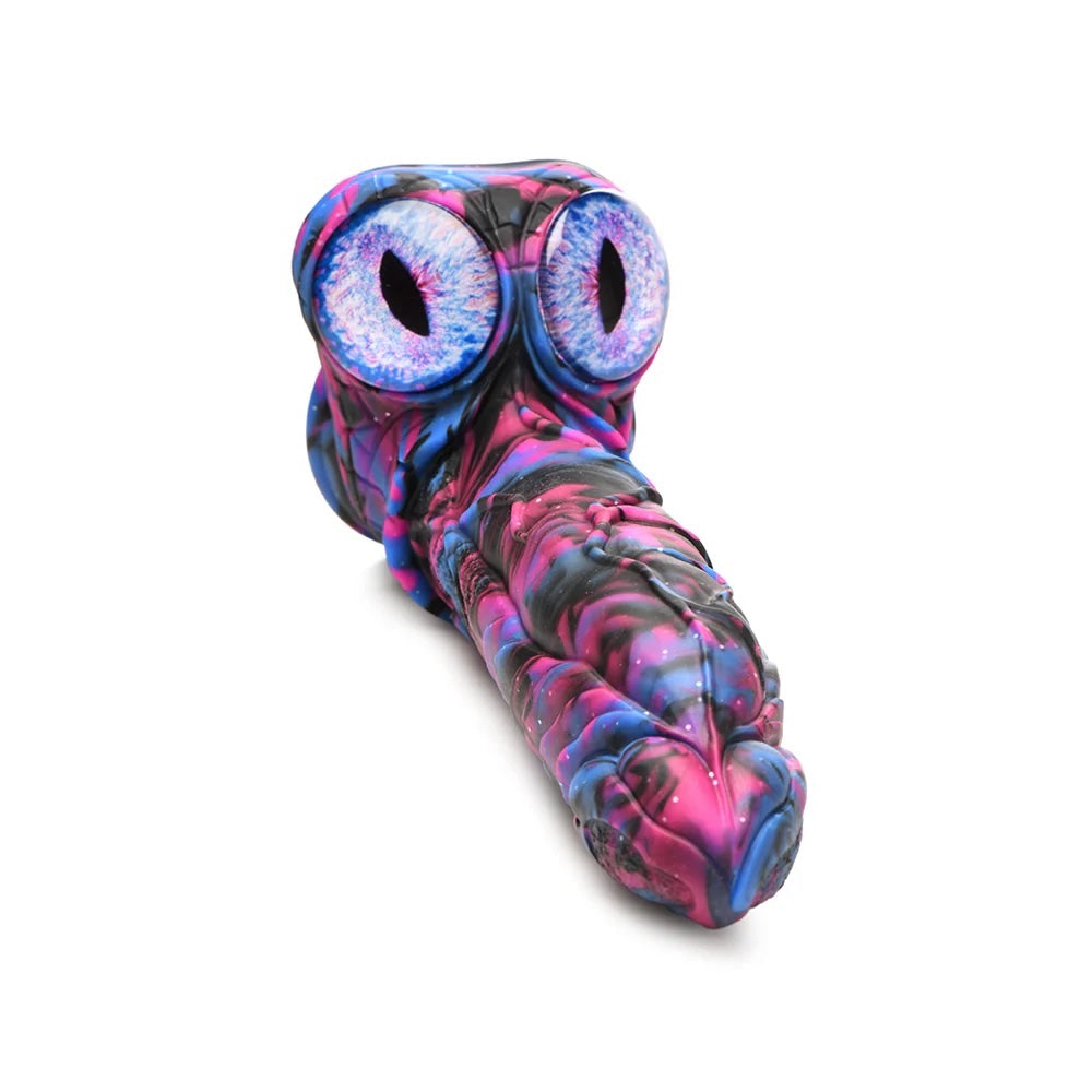 XR Brands Creature Cocks Alienoid Pink, black, blue and glitter silicone fantasy dildo with eye balls for testes from above laid down with he eyeball testes facing up