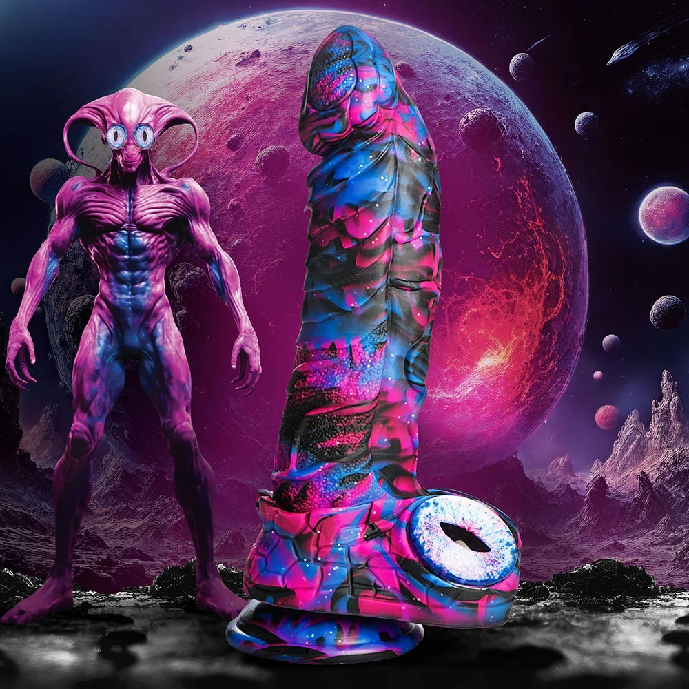 XR Brands Creature Cocks Alienoid Pink, black, blue and glitter silicone fantasy dildo with eye balls for testes  side view next to an alien being in  space and a moon in the background